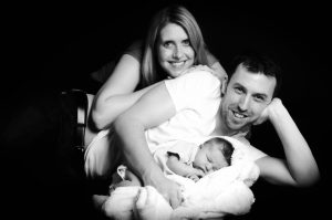 Portrait of young Derby parents with their new born baby