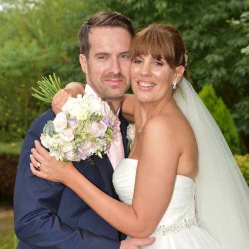 Wedding Photographers in Derby - Champagne Package - Bride and Groom holding each other and smiling.